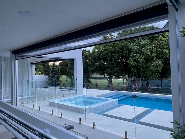 Retractable screen fully retracted, leaving an uninterrupted pool view